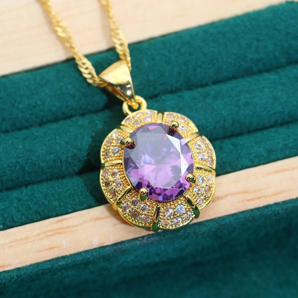 Gold-plated jewellery set with necklace, earrings, ring, and bracelet featuring blue cubic zirconia stones.
