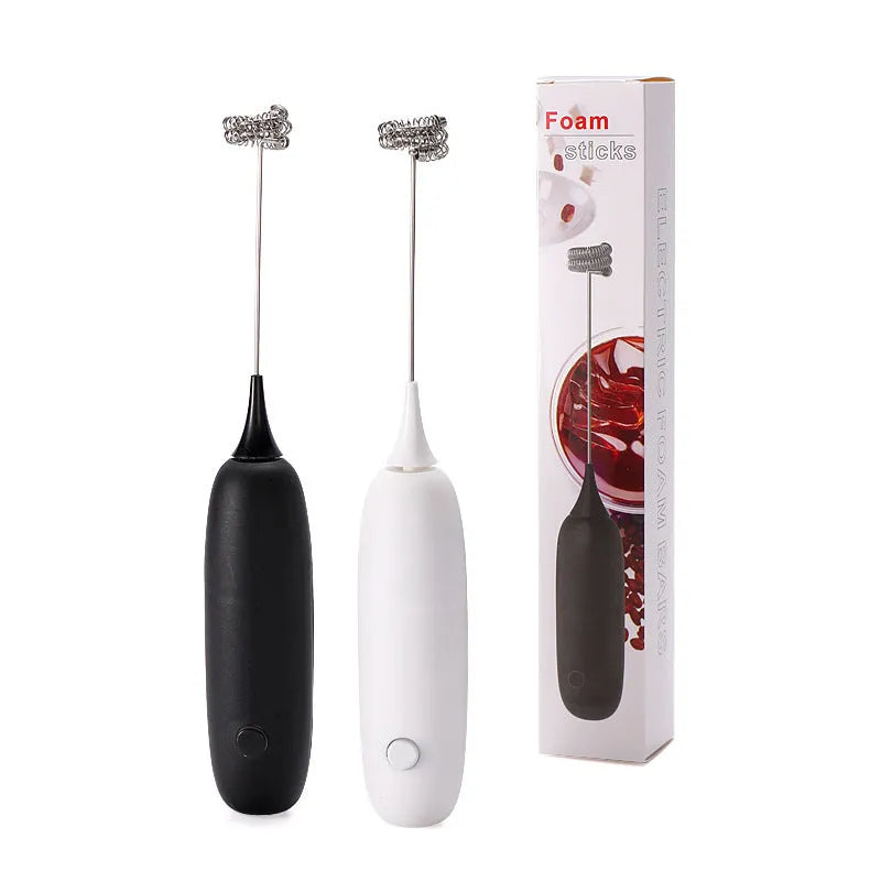 Black and white handheld electric milk frother with whisk attachment for coffee and beverage preparation