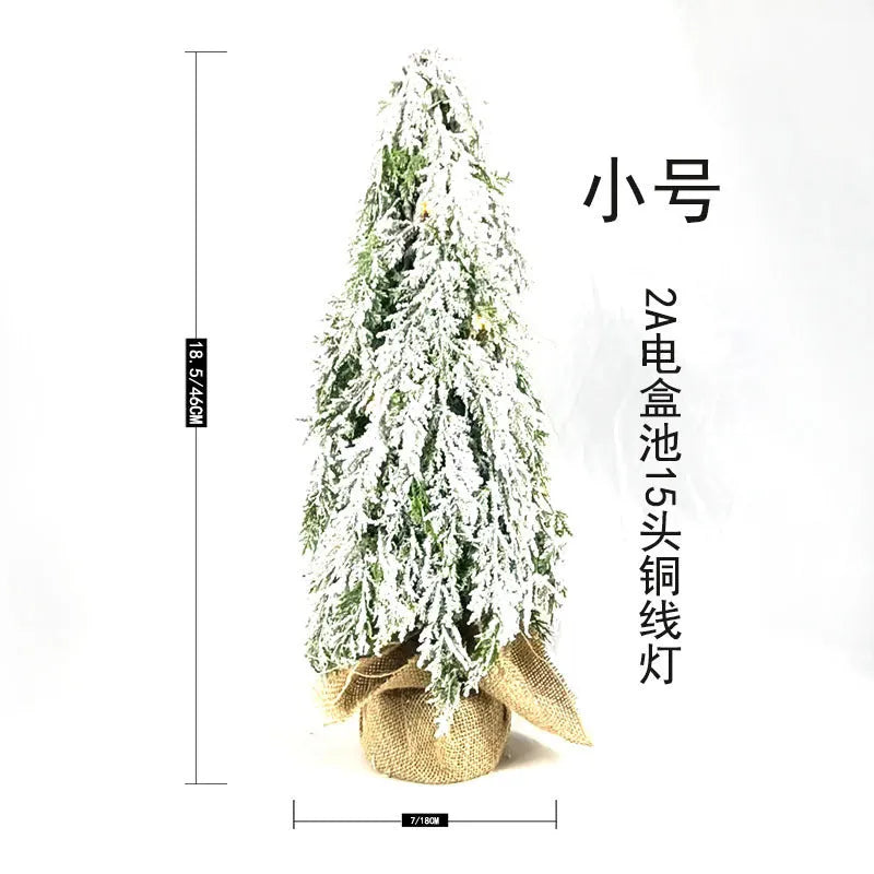 Small 24-inch desktop artificial Christmas tree with white snow sprayer effect and integrated coloured lights