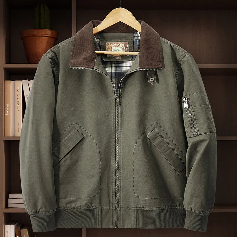 Men's beige washed cotton flight jacket on a hanger, showing its simple design and cotton fabric texture.