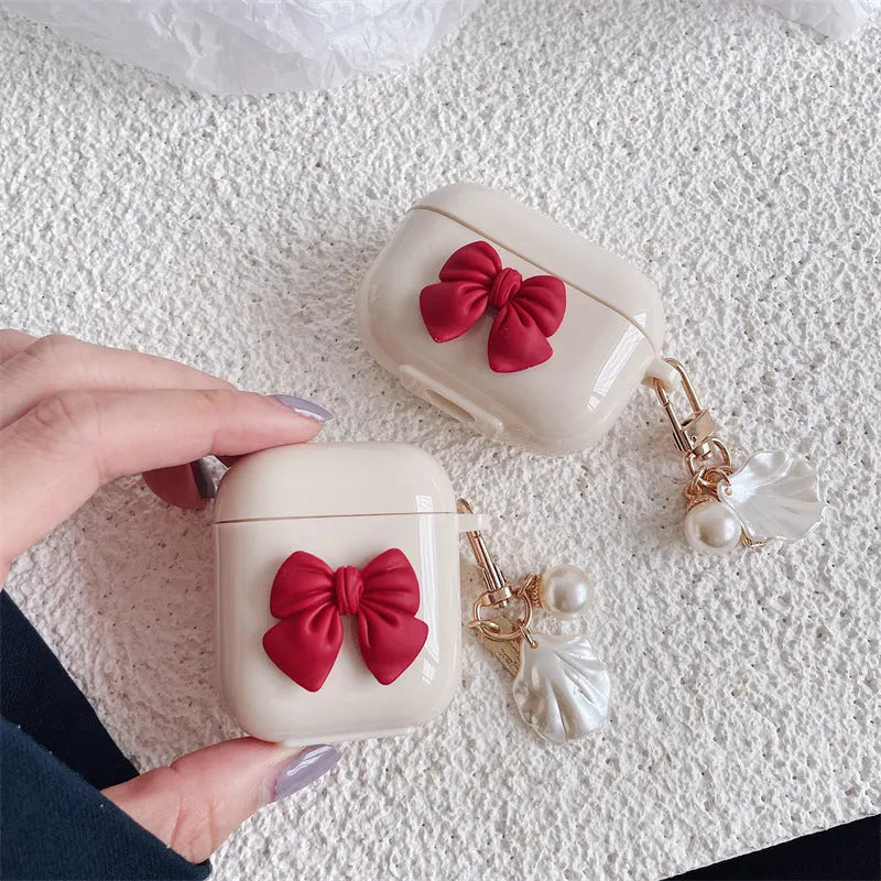 Beige red bow shell clamshell TPU protective cover for AirPods Pro wireless earphone case.
