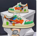 Lace-up casual sneakers in white, blue, and rainbow colour options with simple plain design