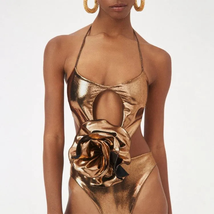 Gold women's halter neck one-piece swimsuit with hollow-out design on mannequin
