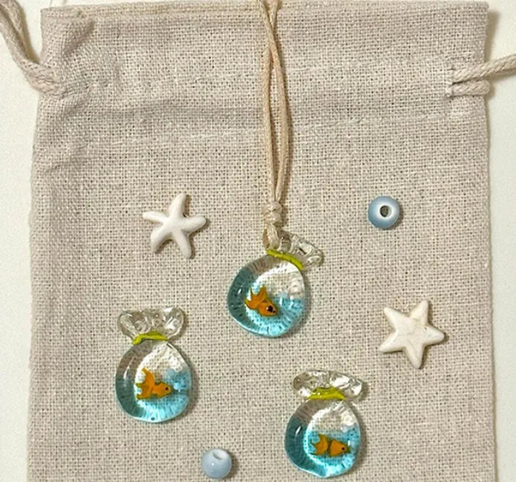 Women's joker pendant necklace with coloured glaze ornament on a cotton and linen clavicle chain.