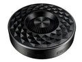 Compact black portable Bluetooth speaker on a table, showing its small size and design.