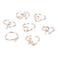 Gold coloured unisex alloy initial ring with letter A geometric shape on a flat surface