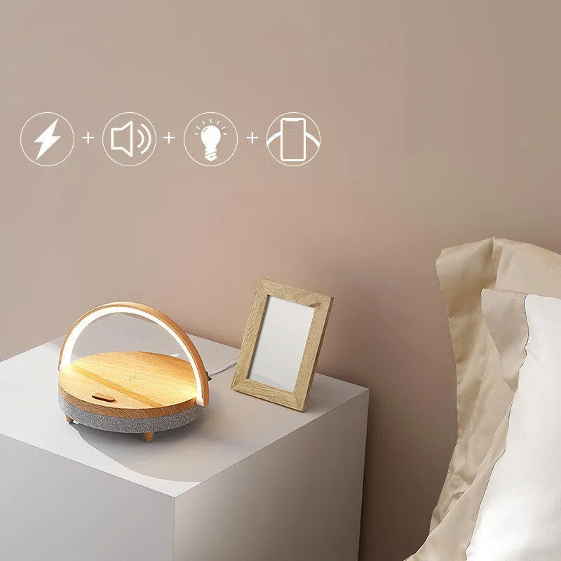 Wireless charging LED night light with Bluetooth speaker in marble finish showing phone on charging pad