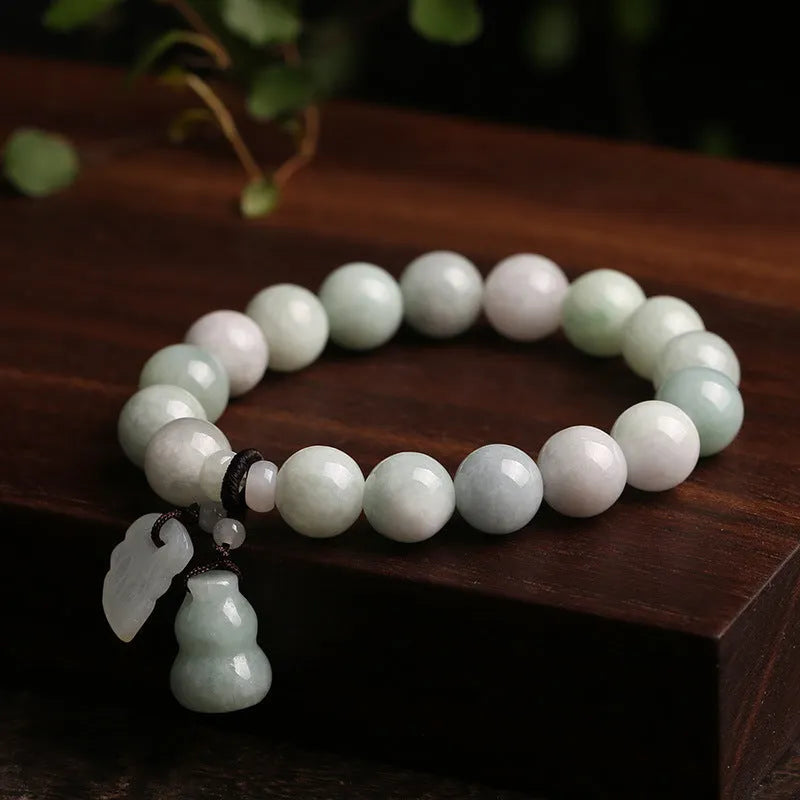 Natural emerald jade bracelet with hanging Maitreya Buddha charm and geometric design