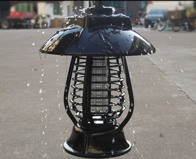 White outdoor solar mosquito lamp with solar panel on top and purple LED light beads visible.