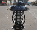 White outdoor solar mosquito lamp with solar panel on top and purple LED light beads visible.