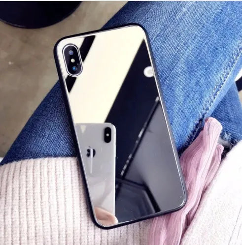 Black iPhone mirror phone case showing reflective surface on back, compatible with iPhone X and other models.