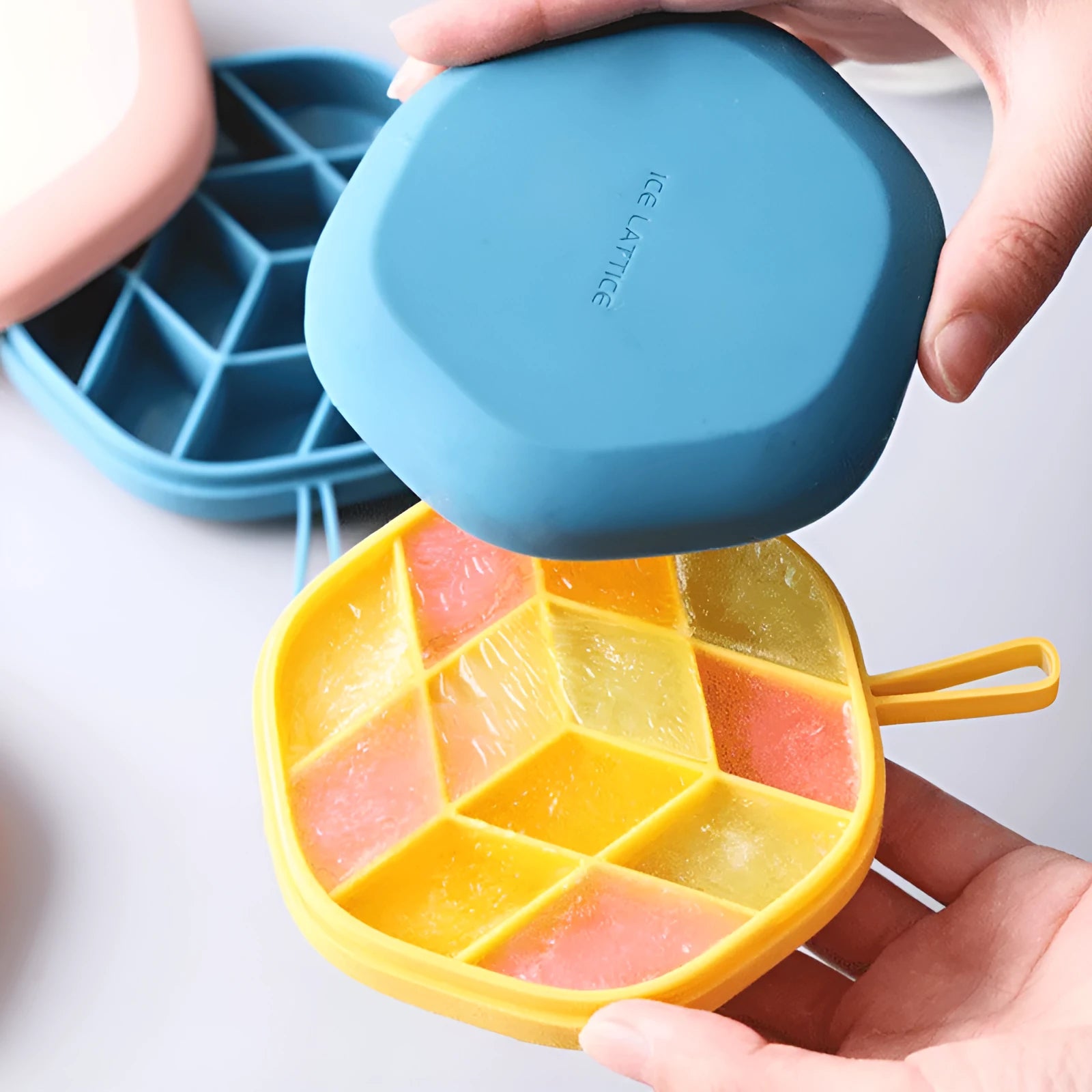 Silicone 12 cavity hexagon ice cube mold in blue with diamond shaped cavities on white background