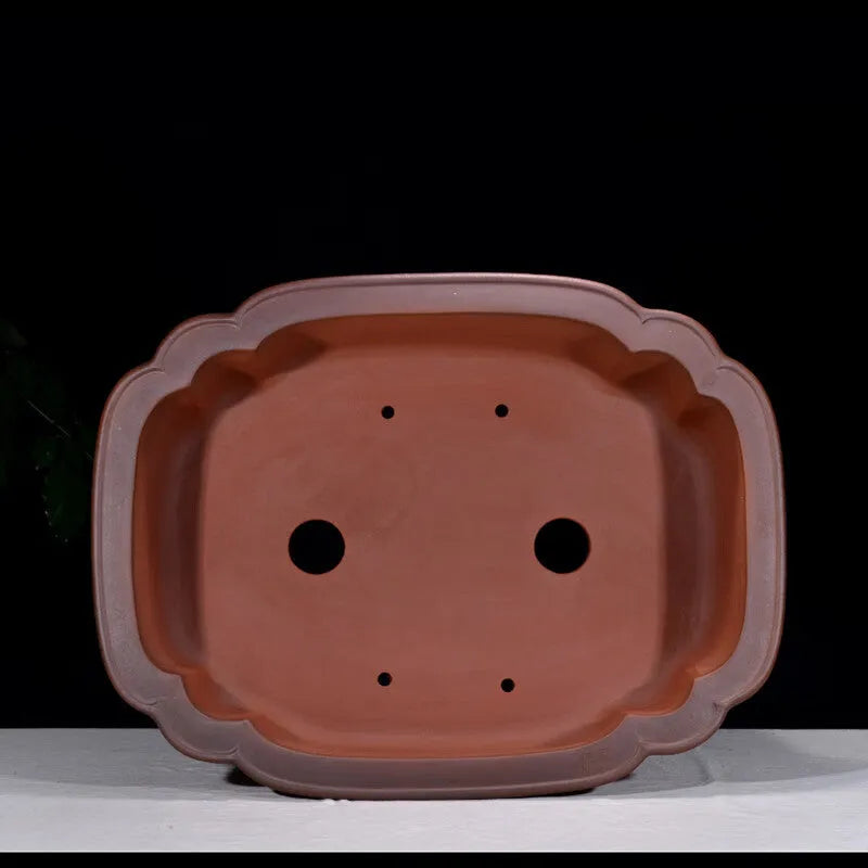 Large antique-style purple clay Chinese flower pot showing wide, shallow shape.