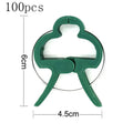 Green plastic and zinc plant fixing clips, showing large and small sizes for supporting climbing vegetables.