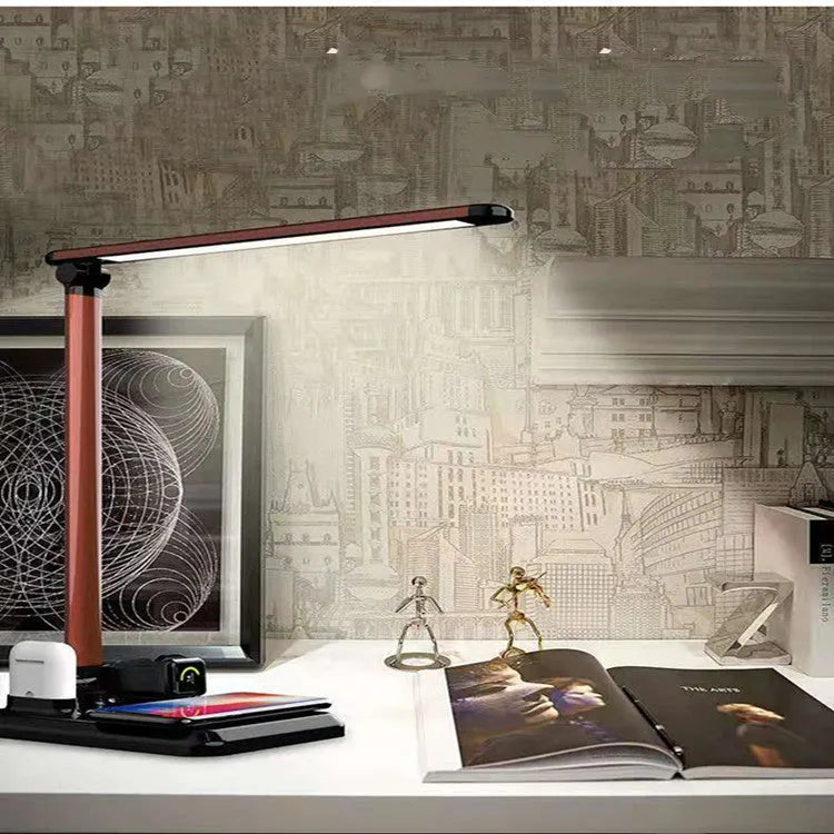 Black 4-in-1 LED desk lamp with adjustable arm and wireless charging pad for mobile phones