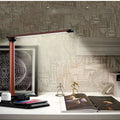 Black 4-in-1 LED desk lamp with adjustable arm and wireless charging pad for mobile phones