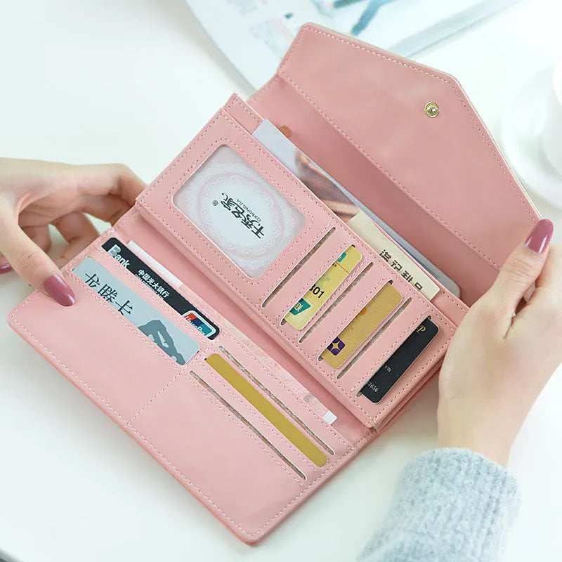 Student three-fold leather wallet with buckle clip closure shown in multiple colour options