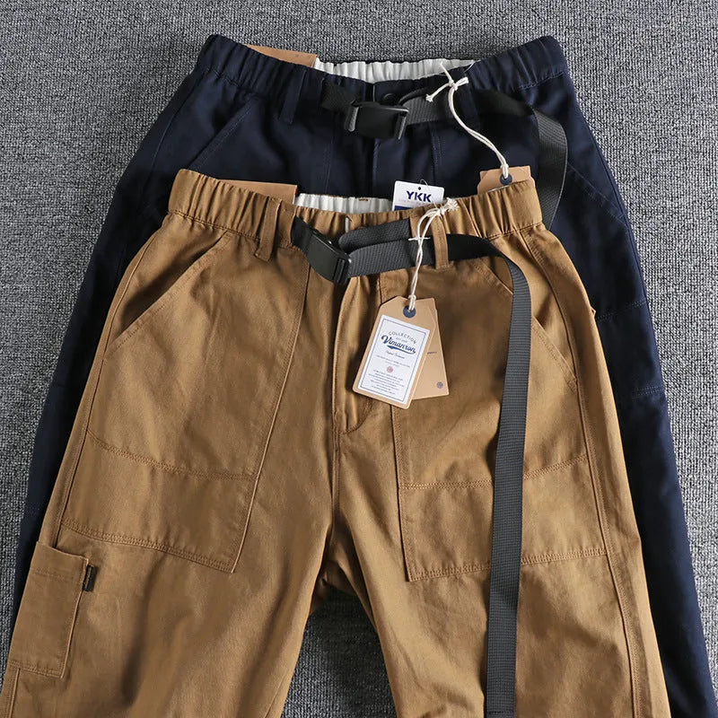 Men's khaki cotton work trousers with N I buckle belt showing three-dimensional cutting detail