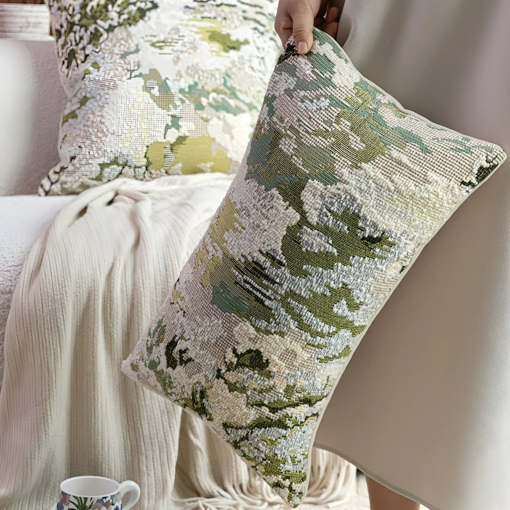 Green abstract plants and flowers pattern wool blend cushion cover on a sofa, showing square and waist pillow sizes.
