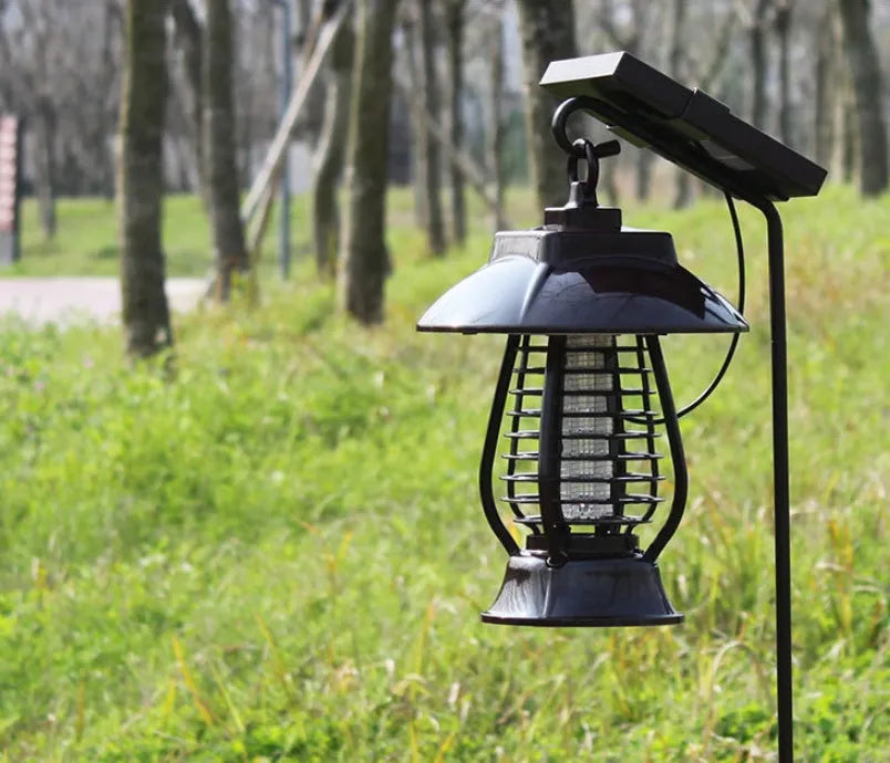 White outdoor solar mosquito lamp with solar panel on top and purple LED light beads visible.