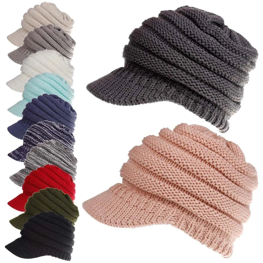 Woman wearing a thick knitted beanie with a ponytail threaded through the hole in the crown.