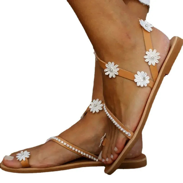Brown flat beach sandals with herringbone toe design and floral pattern on the artificial PU upper.