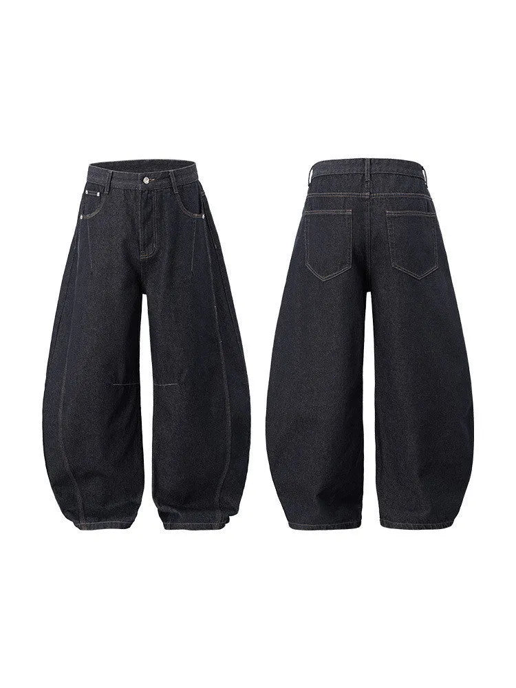 Men's wide leg denim trousers in original cow colour on a hanger, showing the relaxed fit and mid waist design.