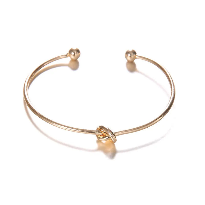 Gold vintage cuff bracelet with knotted arrow design for women