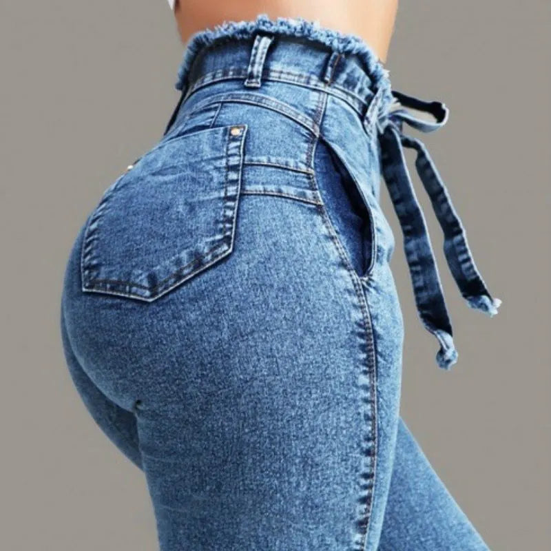 A pair of dark blue fringed jeans made from cowboy denim on a mannequin