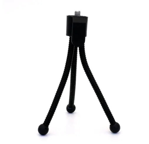 Small aluminium tripod with ball head collapsed to 110mm height next to mobile phone