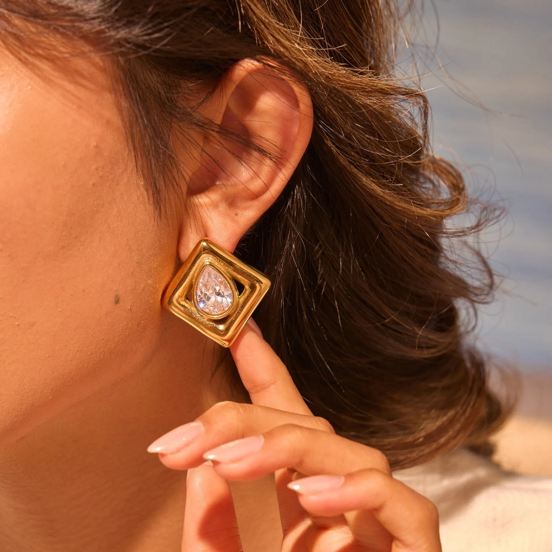 Gold geometric stud earrings with water drop zircon inlaid detail on stainless steel