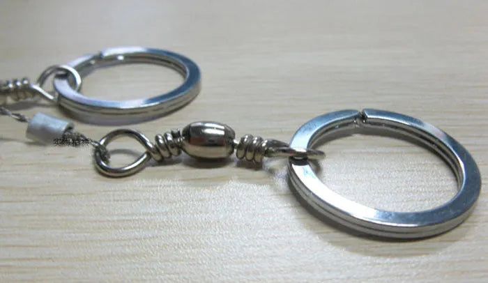 Stainless steel survival wire saw with pull rings, 55cm blade for outdoor wood cutting.