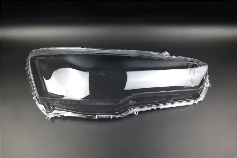 Clear plastic car headlight housing cover with dimensions 50mm by 30mm by 20mm.