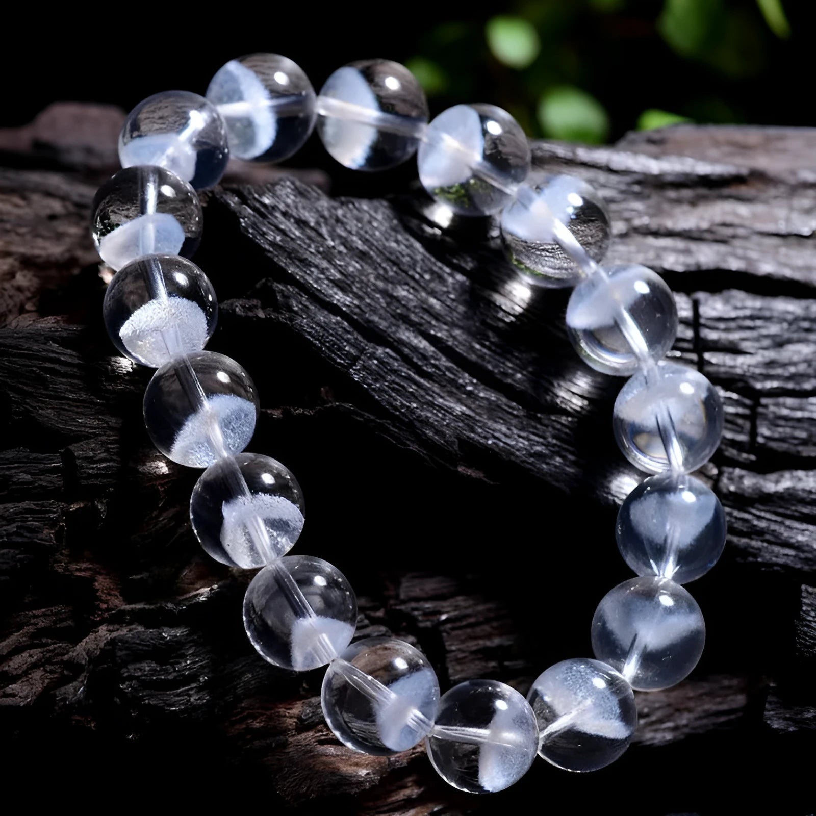 Women's white crystal pyramid bead bracelet with a Ruyi charm on a wrist.
