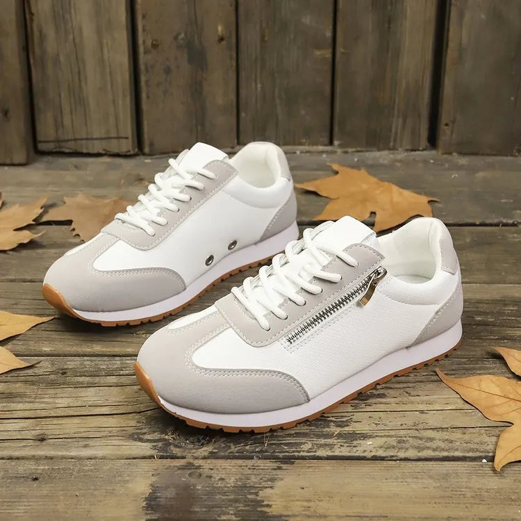 Women's flat shoes in champagne, grey or white with artificial PU upper and rubber sole.