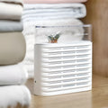 White recyclable cabinet dehumidifier box with clear top showing colour-changing silica gel beads.