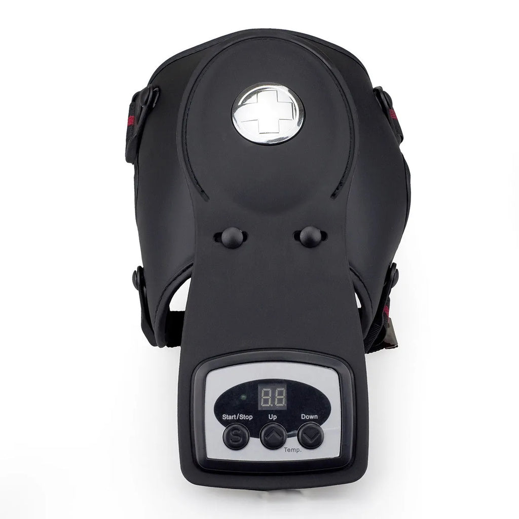 Infrared heat therapy knee and shoulder massager with pads and power adapter on a table.