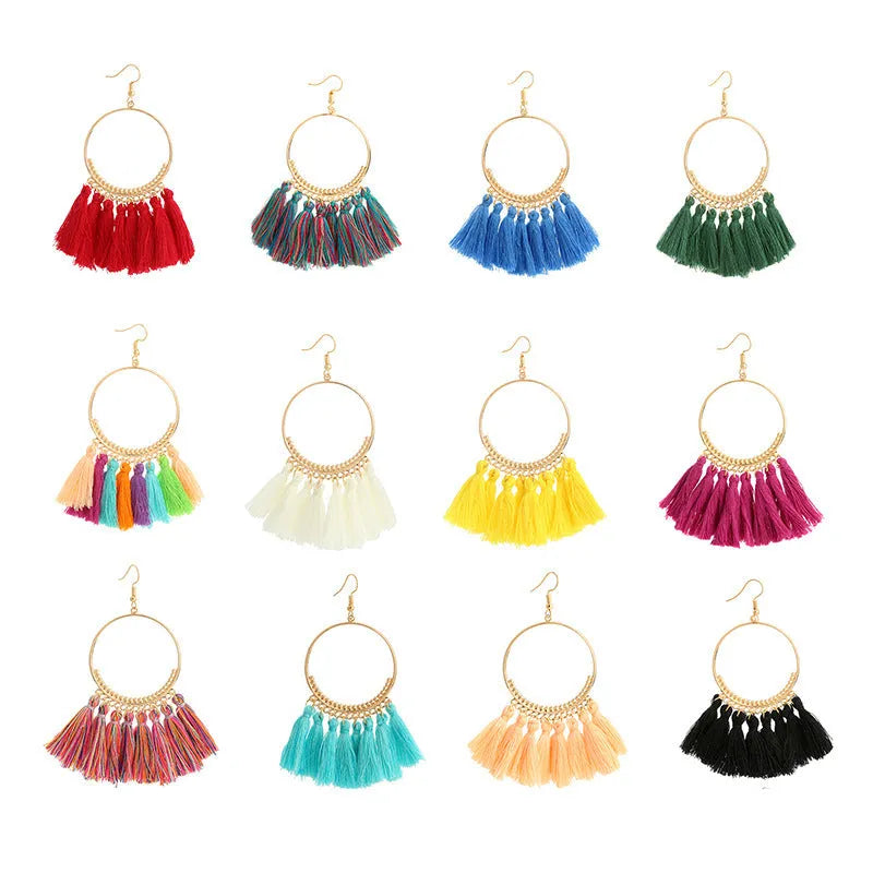 Big round drop dangle earrings in hand-woven geometric alloy design on white background
