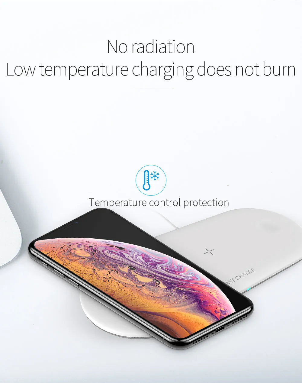 White three-in-one wireless charging stand holding an iPhone, Apple Watch, and AirPods on a wooden desk.