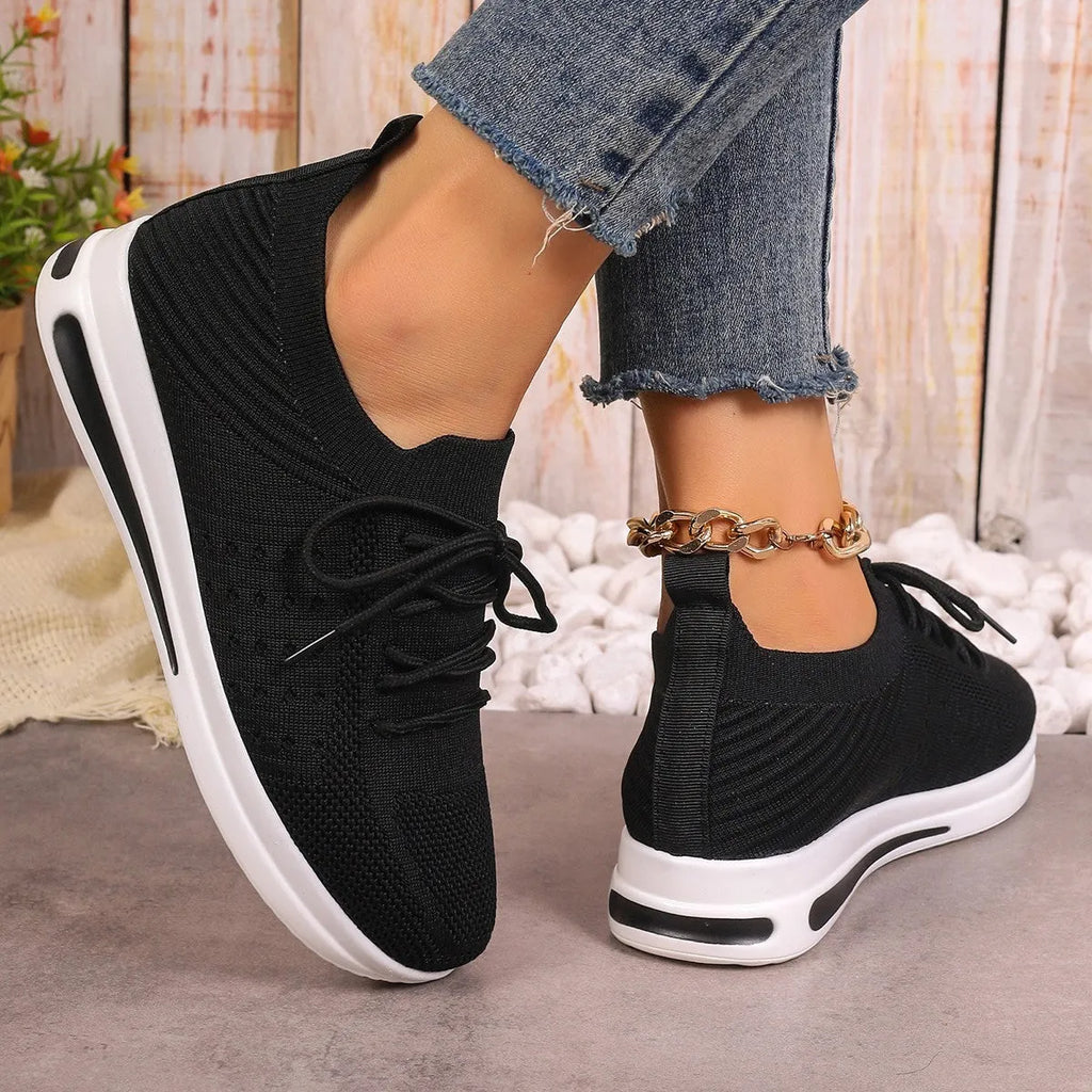 Women's red fly-knit casual sneakers with round toe and lace-up front on a white background
