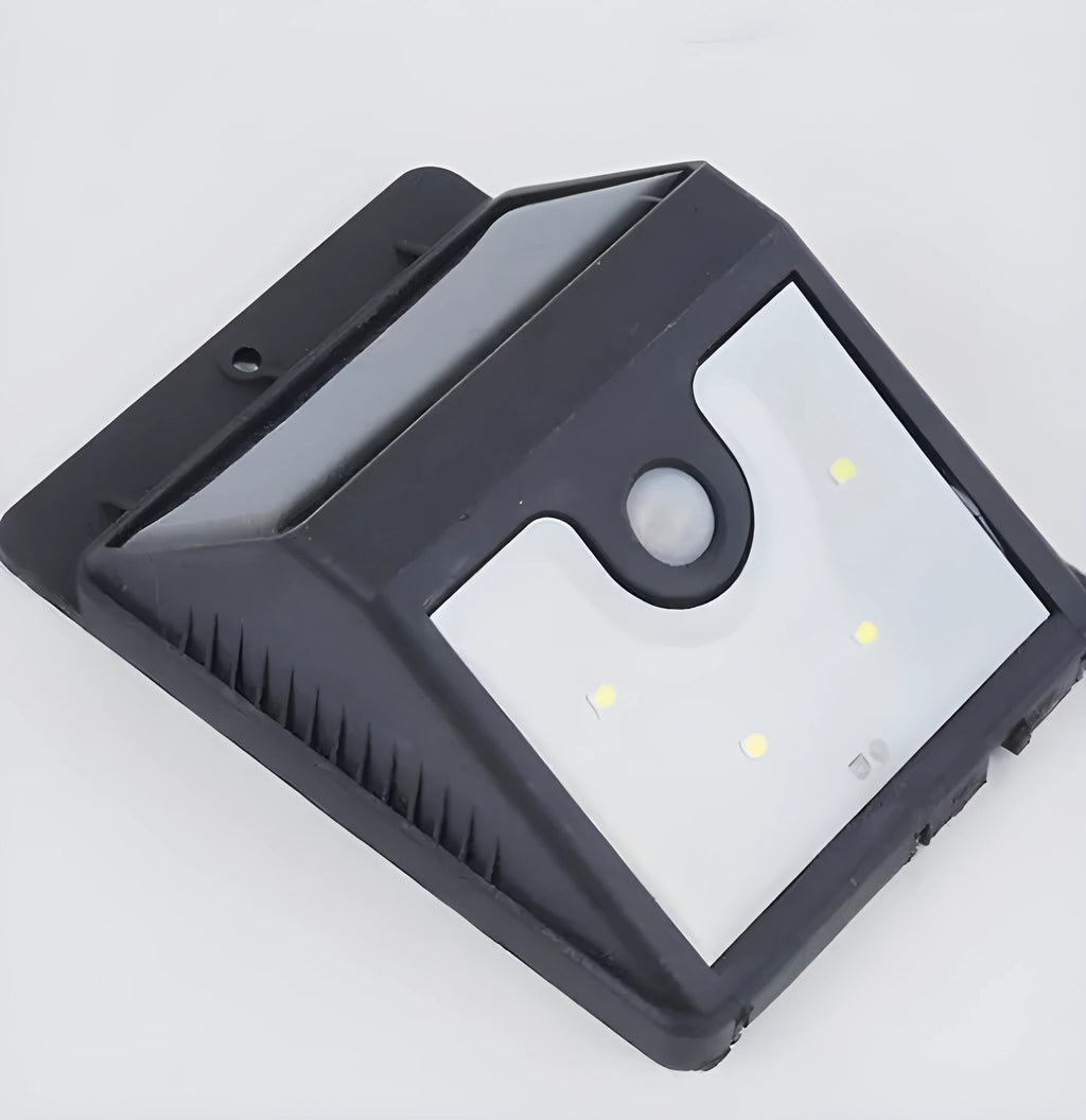 Set of four black solar-powered LED motion sensor lights for outdoor garden and pathway lighting
