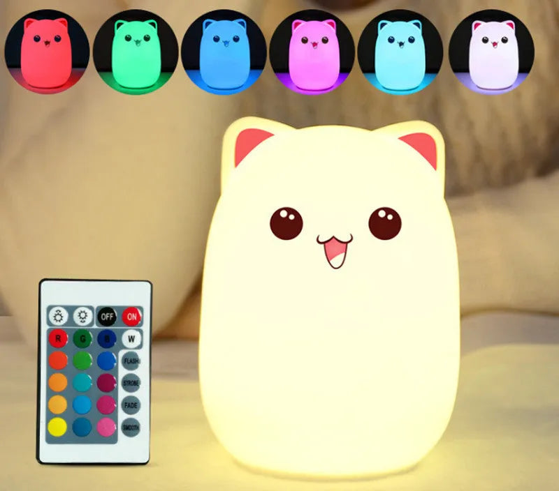 Cartoon silicone clap lamp in blue with warm white light mode on a wooden bedside table