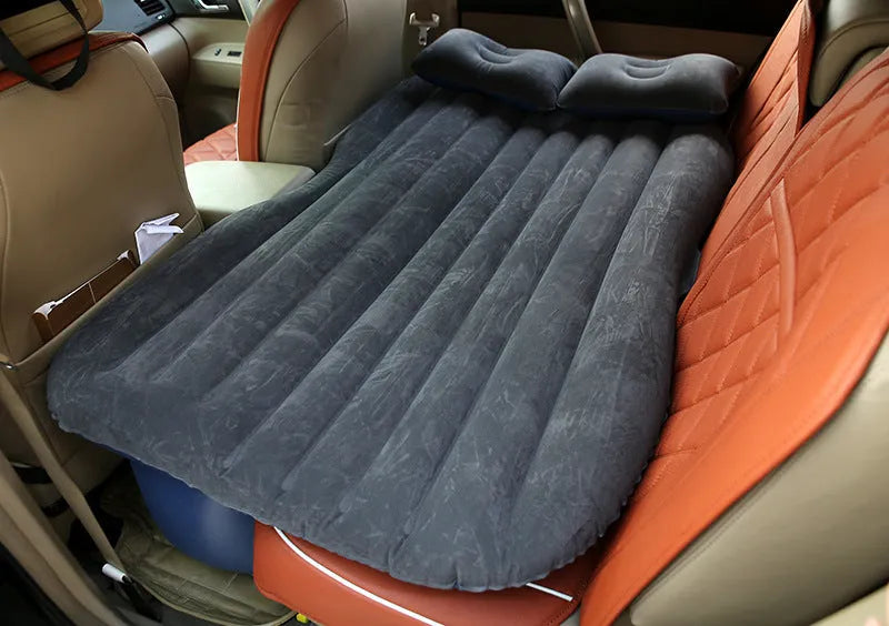 Black inflatable car bed with flocked surface, two pillows, and storage bag for five-seater vehicles