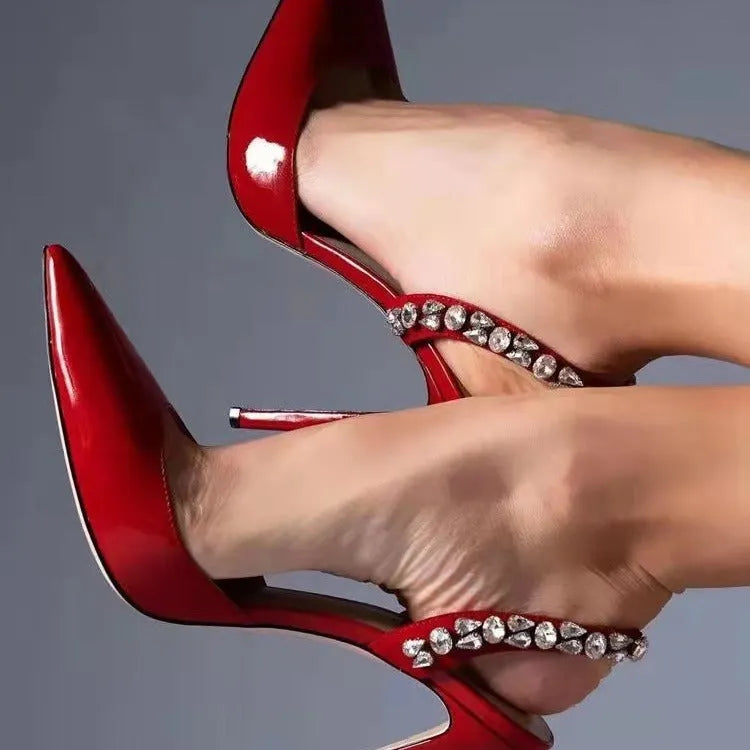Women's black pointed toe high heel sandals with rhinestone decoration on the side.