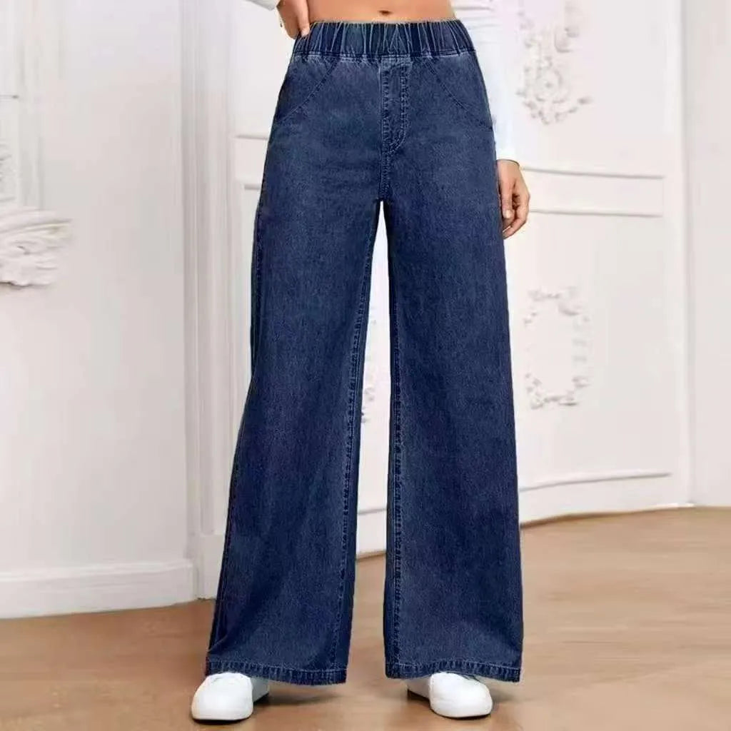 Women's light blue washed wide-leg jeans with straight cut trousers and mid-waist zip fly