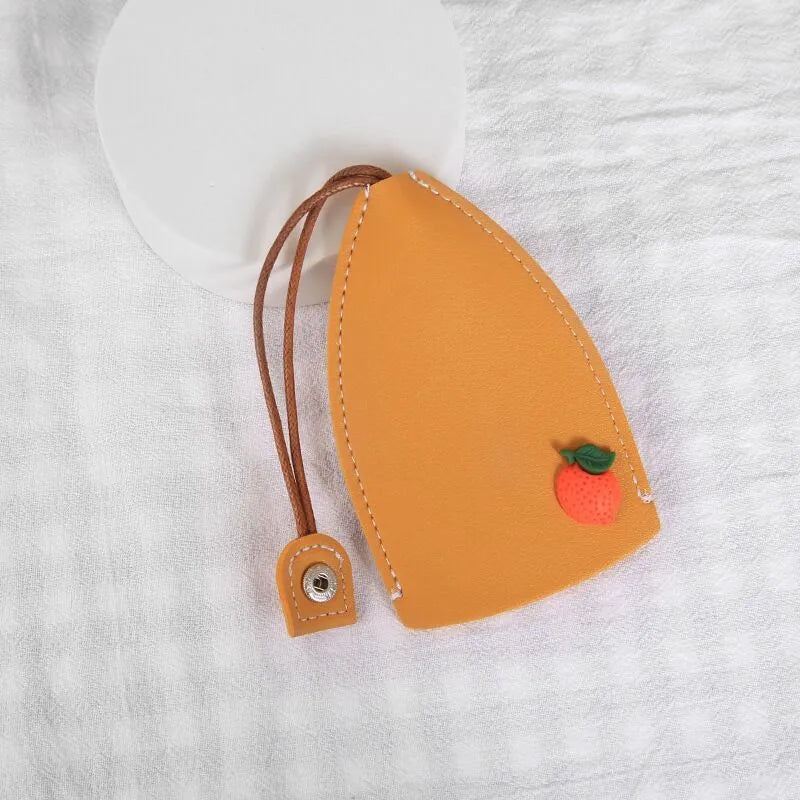 Colourful cartoon pull-out key protector case made from PU leather, showing a selection of fruit and animal designs.