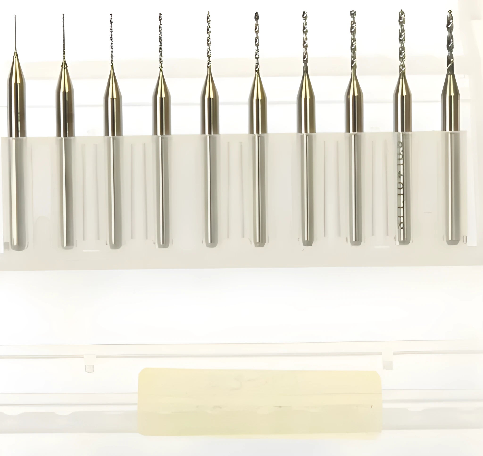 Close-up of imported tungsten carbide micro-engraving bits in various sizes from 0.10mm to 2.00mm diameter.
