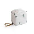 Blue cloth cube makeup storage bag with zip on a bathroom countertop.