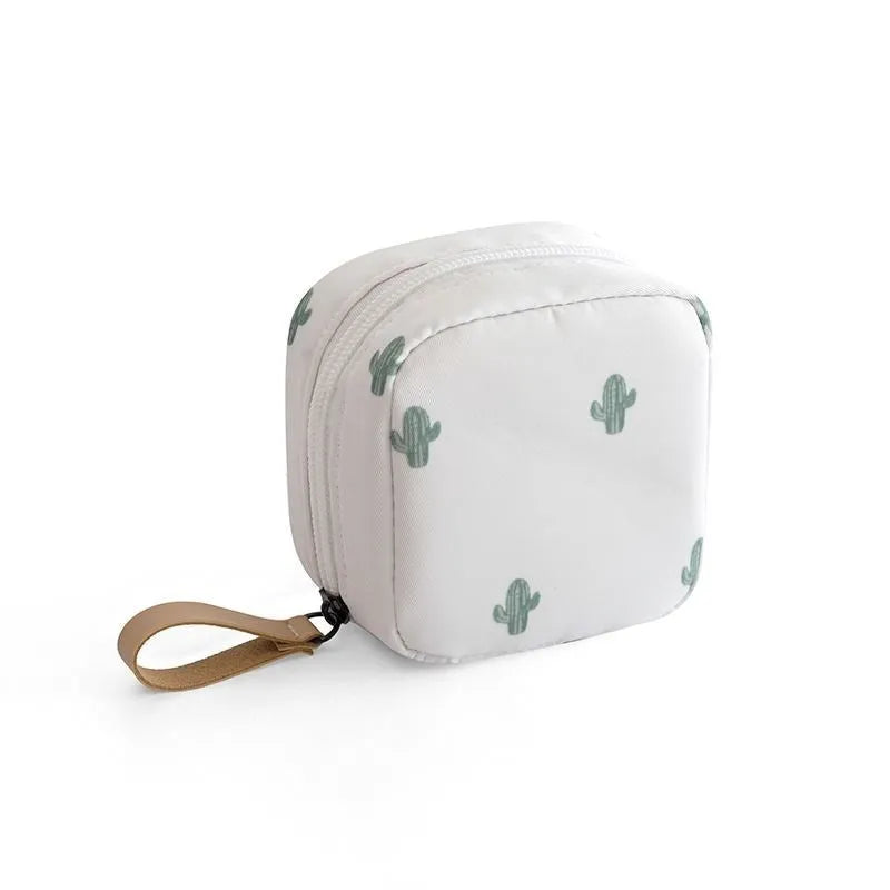 Blue cloth cube makeup storage bag with zip on a bathroom countertop.