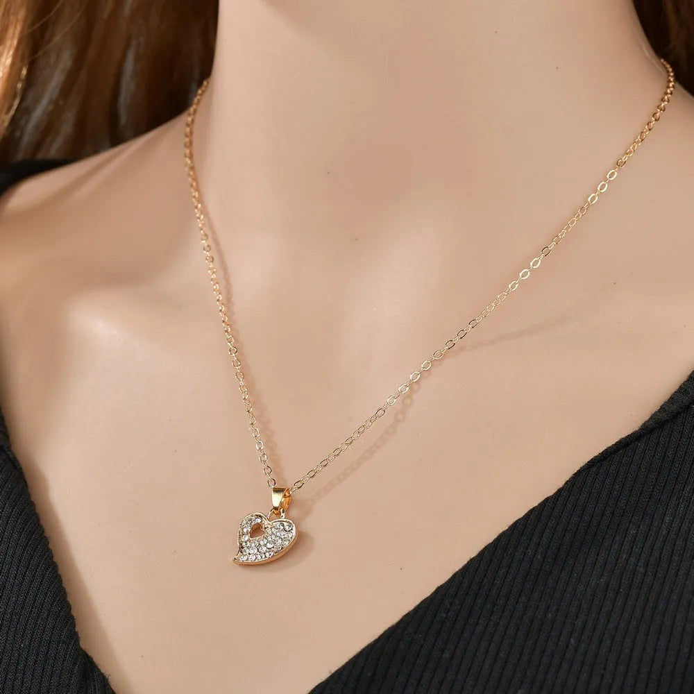 Gold colour women's jewellery set with earrings, pendant and adjustable bracelet featuring love, water drop and bell patterns